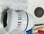 A white electronic device resembling a mini air purifier or humidifier with vents around it is placed on top of a sheet with instructions. Surrounding items include a screwdriver with a blue handle, a grey round object for callus removal, and part of a plastic case. This device is the ExZachly Perfect Multifunctional Electric Foot File Grinder Machine Dead Skin Callus Remover.