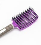 A close-up of a purple Hairbrush Anti Klit Brushy Haarborstel with black bristles and a beige, textured handle on a white background. The ExZachly Perfect hairbrush features a wide, curved head designed for detangling and styling hair while providing a gentle scalp massage.