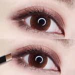 Close-up of an eye with a brown iris, showcasing shimmery pink eyeshadow and eyeliner on both upper and lower eyelids. This two-color cosmetic look features the eye open in the top image, while the bottom image shows an ExZachly Perfect Two-tone eye shadow stick lazy eye shadow being applied to achieve a natural look.